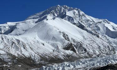 Sishapangma Expedition - Stunning view of snow-covered Sishapangma, the 14th highest peak, towering over the rugged Tibetan landscape during the expedition.