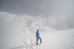 A climber ascending through snow-covered paths on the Annapurna Expedition – A Journey to Conquer Nepal’s Majestic Peak.