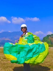 Paraglider setting up equipment before taking off on a Taktok Brothers Paragliding Adventure.