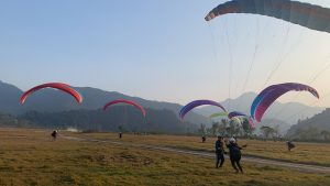 Paragliders preparing to take flight on a Taktok Brothers Paragliding Adventure.