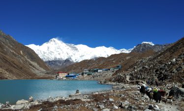 Lower Dolpo Trek in Nepal, featuring a stunning view of Shey Phoksundo Lake and snow-capped mountains.