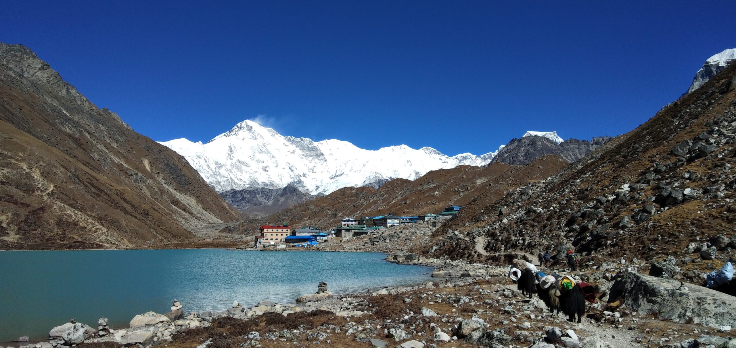 Lower Dolpo Trek in Nepal, featuring a stunning view of Shey Phoksundo Lake and snow-capped mountains.